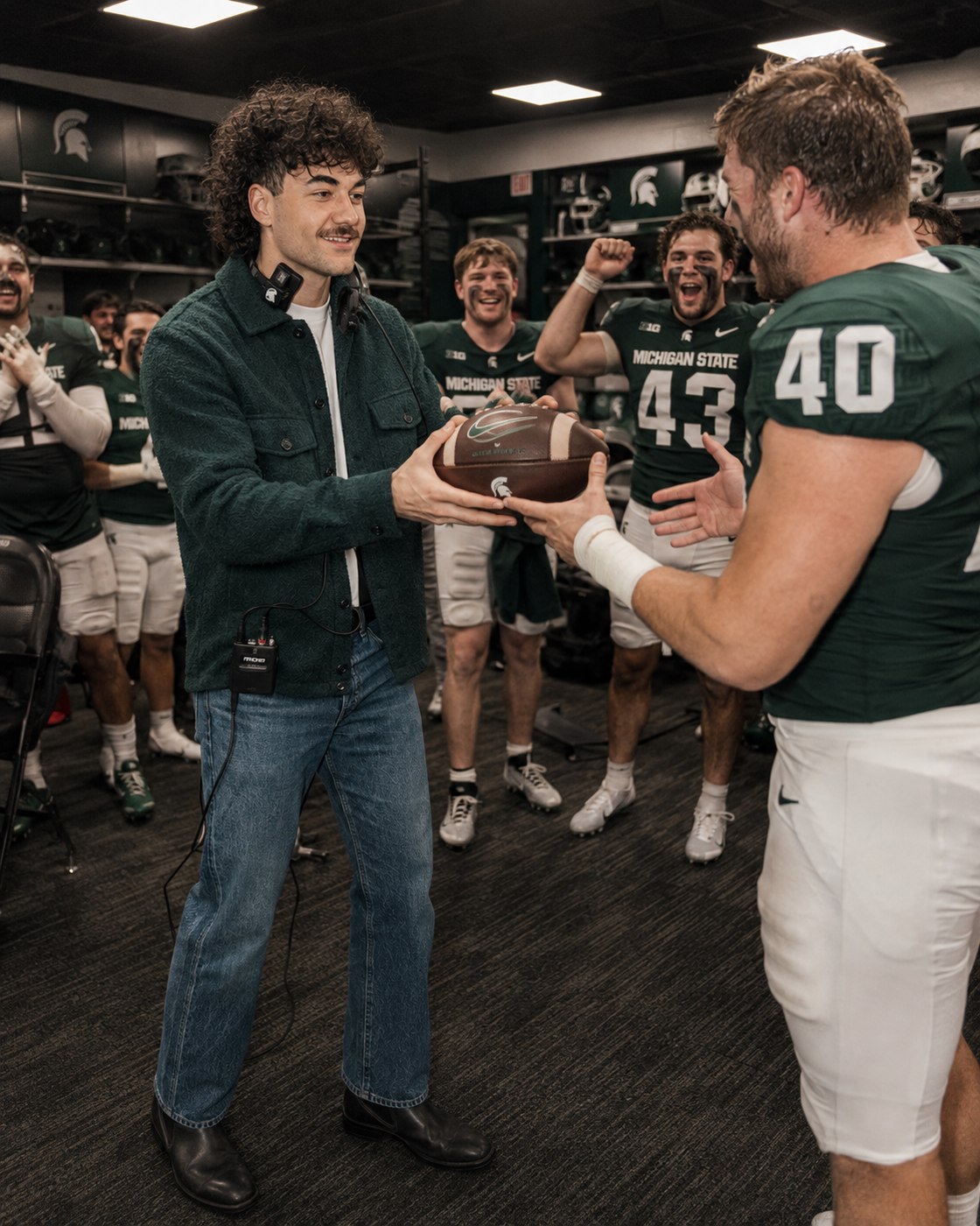Nick Mansour handing out a game ball in the Michigan State locker room.