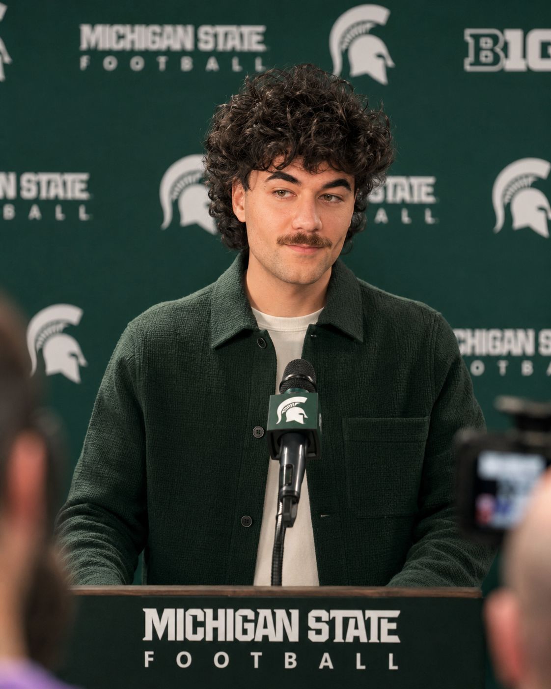 Nick Mansour at the podium for his Tuesday game-week press conference